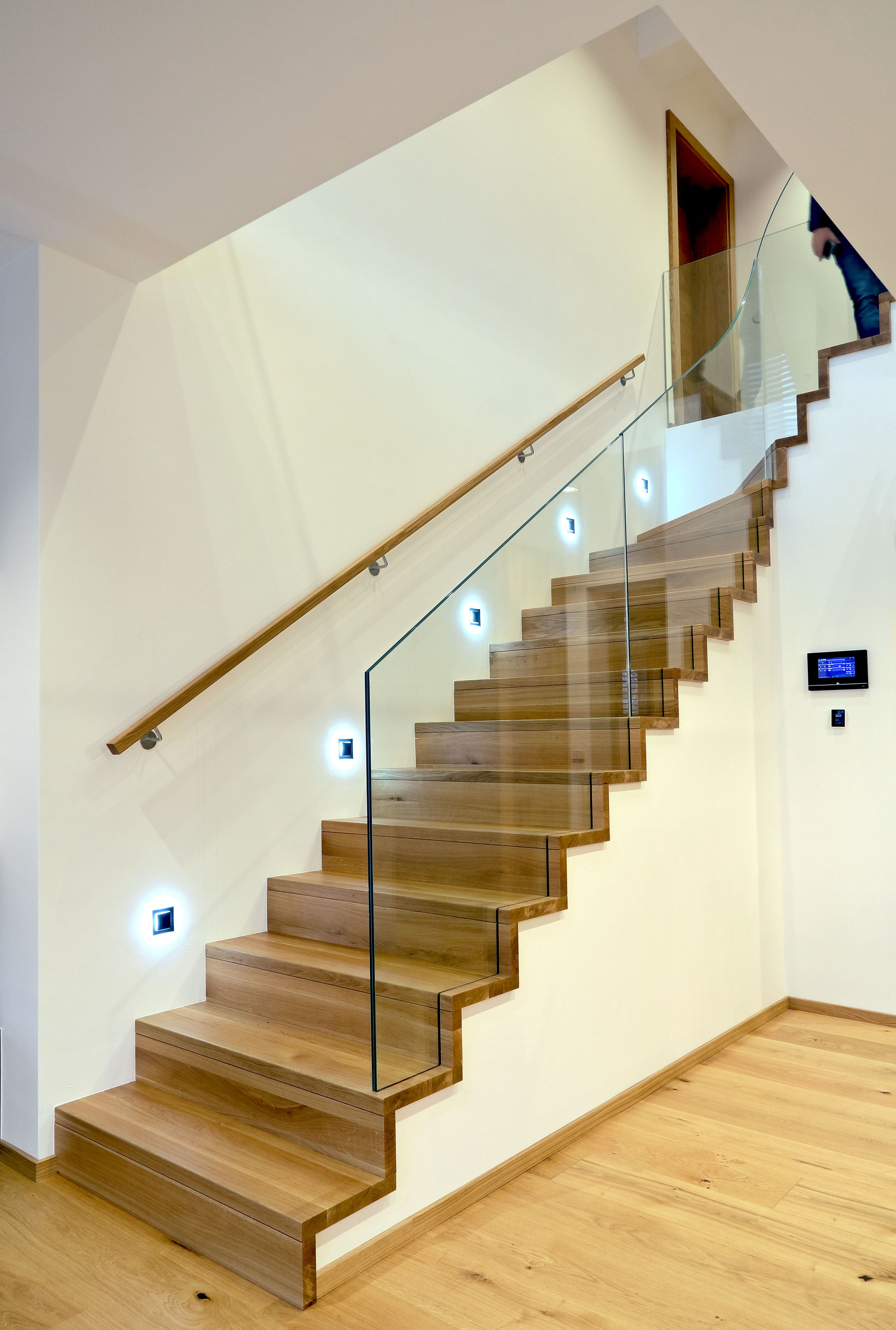 Moderne Betonstiege mit Holzstufen und Glasgeländer
